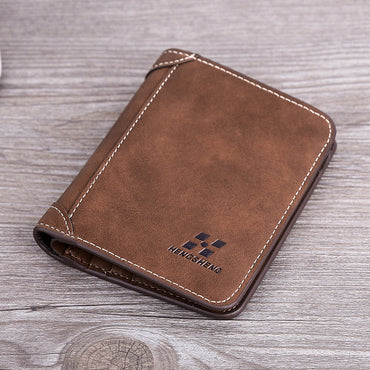 Brown leather wallet with visible brand logo on a wooden surface